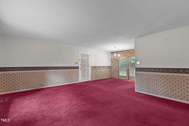 18 Red Pine Rd, Chapel Hill, NC 27516 - unfurnished room with wallpapered walls, a textured ceiling, a wainscoted wall, carpet, and a chandelier