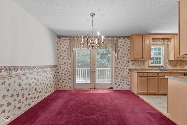 18 Red Pine Rd, Chapel Hill, NC 27516 - kitchen with wallpapered walls, a chandelier, french doors, a textured ceiling, and light brown cabinetry