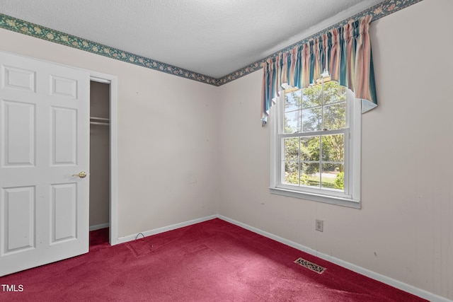 18 Red Pine Rd, Chapel Hill, NC 27516 - unfurnished bedroom with carpet floors, a textured ceiling, and a closet