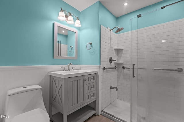 18 Red Pine Rd, Chapel Hill, NC 27516 - bathroom featuring wainscoting, a shower stall, vanity, and wood finished floors