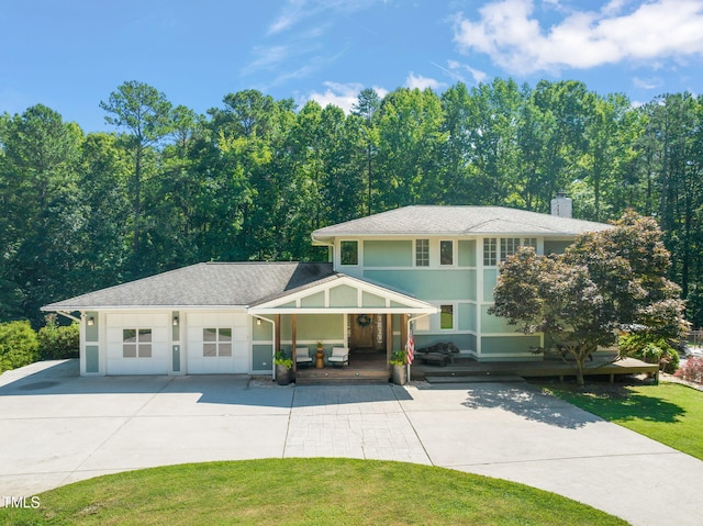1209 Ravens Point Cir, Raleigh, NC 27614 - view of front of property featuring concrete driveway, covered porch, an attached garage, a chimney, and a front lawn