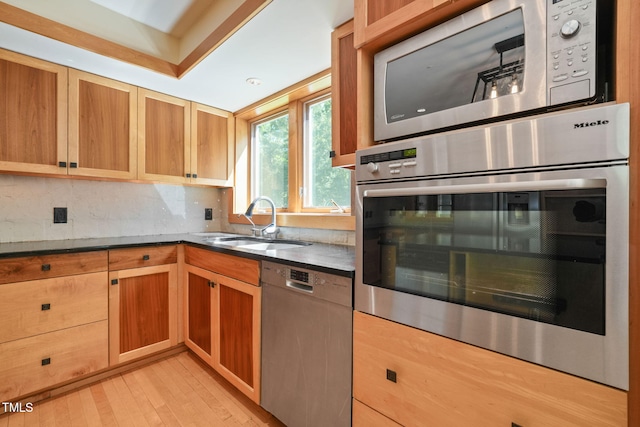 1209 Ravens Point Cir, Raleigh, NC 27614 - kitchen with appliances with stainless steel finishes, decorative backsplash, and light wood finished floors
