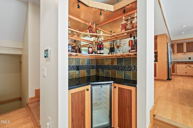 1209 Ravens Point Cir, Raleigh, NC 27614 - indoor dry bar with stainless steel refrigerator, decorative backsplash, beverage cooler, and light wood finished floors