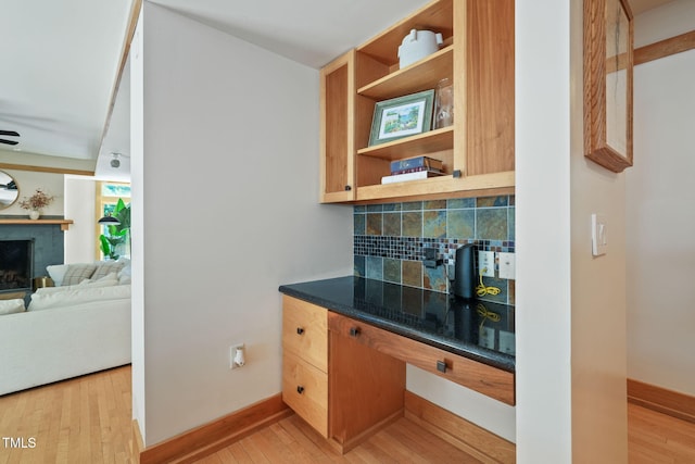 1209 Ravens Point Cir, Raleigh, NC 27614 - bar with backsplash, light wood-style floors, and a tile fireplace