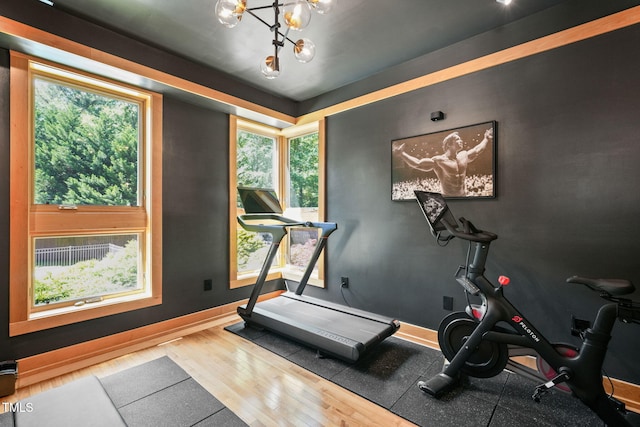 1209 Ravens Point Cir, Raleigh, NC 27614 - workout room with wood finished floors and a chandelier