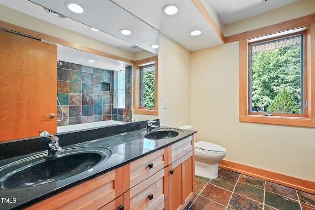 1209 Ravens Point Cir, Raleigh, NC 27614 - bathroom with double vanity, stone tile floors, a bathtub, recessed lighting, and a shower
