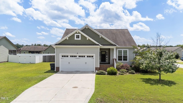 16 Woodglen Dr, Clayton, NC 27527 - view of front of home featuring concrete driveway, an attached garage, a shingled roof, brick siding, and a gate