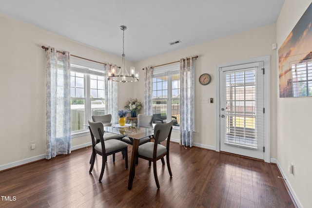 16 Woodglen Dr, Clayton, NC 27527 - dining area with a chandelier and dark wood finished floors