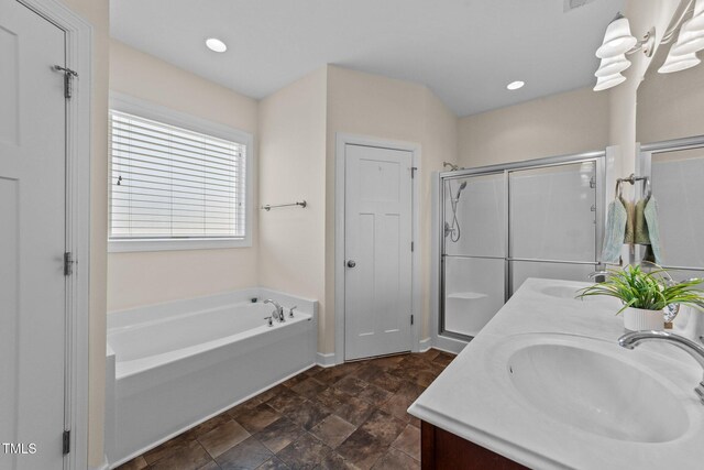 16 Woodglen Dr, Clayton, NC 27527 - bathroom featuring double vanity, a garden tub, a shower stall, and stone finish floors