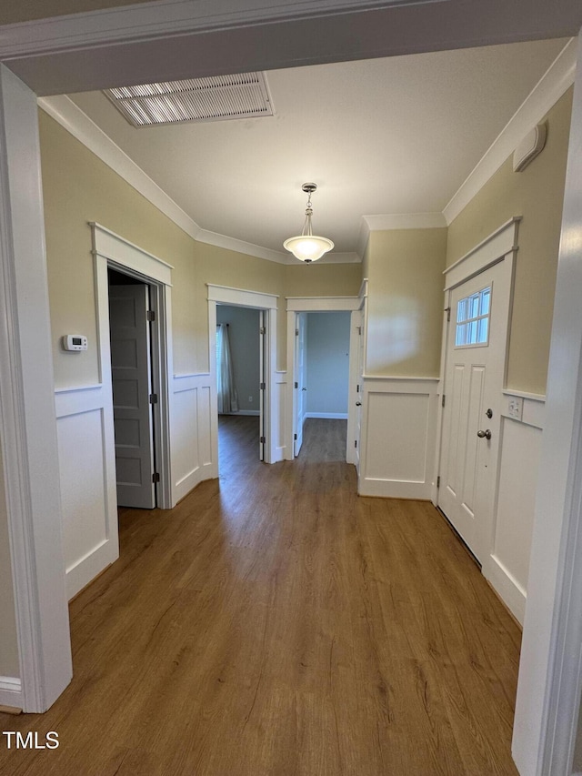 3005 Condor Ct, Deep Run, NC 28525 - unfurnished dining area with a decorative wall, wood finished floors, crown molding, and a wainscoted wall