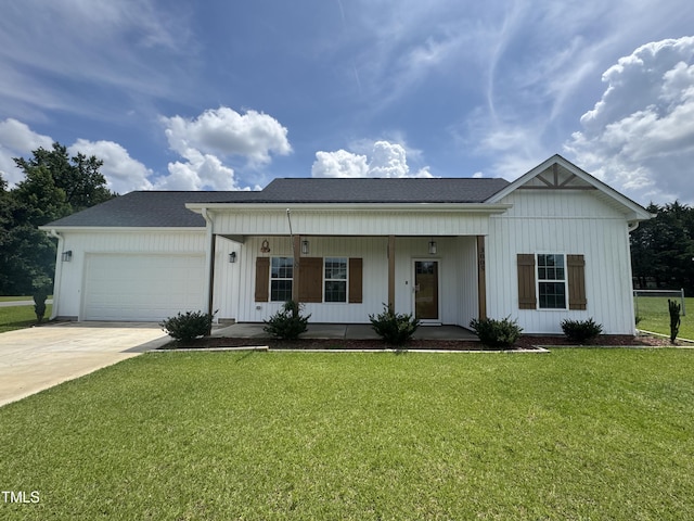 3005 Condor Ct, Deep Run, NC 28525 - view of front of house featuring driveway, a porch, a garage, a front yard, and board and batten siding