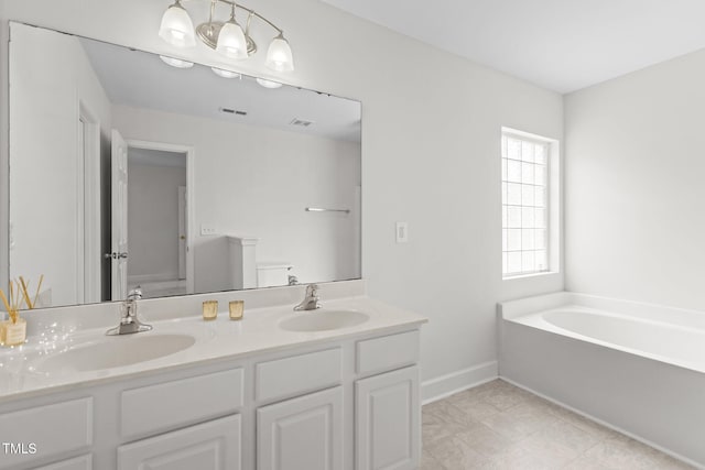 4716 Miller Dr, Durham, NC 27704 - bathroom featuring a bath and double vanity