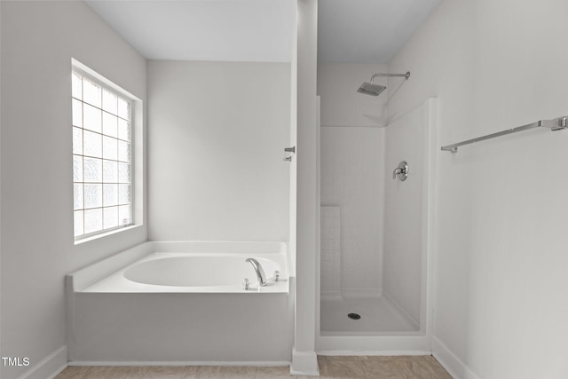 4716 Miller Dr, Durham, NC 27704 - full bathroom with healthy amount of natural light, a garden tub, and a shower stall