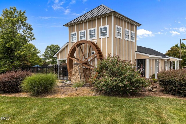 4716 Miller Dr, Durham, NC 27704 - view of front of house featuring a standing seam roof, a metal roof, a gate, and board and batten siding