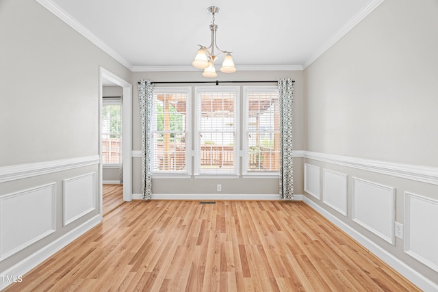 741 Rockville Rd, Wake Forest, NC 27587 - unfurnished dining area with crown molding, light wood-style floors, a chandelier, and wainscoting