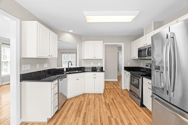741 Rockville Rd, Wake Forest, NC 27587 - kitchen with stainless steel appliances, light wood-style flooring, white cabinetry, and recessed lighting