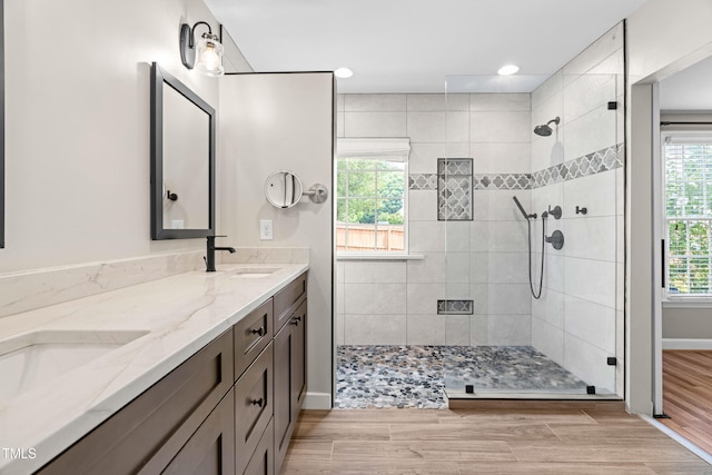 741 Rockville Rd, Wake Forest, NC 27587 - full bathroom with double vanity, a tile shower, wood finished floors, and recessed lighting