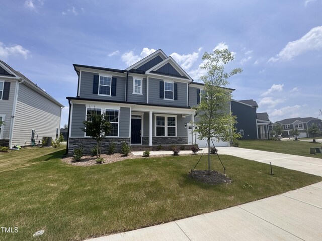 3509 Bailey Lake Dr, Fuquay Varina, NC 27526 - craftsman-style house featuring driveway, stone siding, a front yard, and board and batten siding
