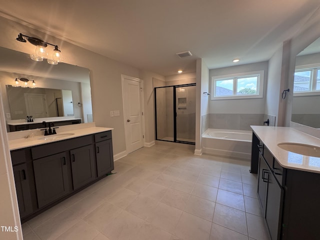 3509 Bailey Lake Dr, Fuquay Varina, NC 27526 - bathroom with two vanities, a stall shower, a bath, healthy amount of natural light, and recessed lighting