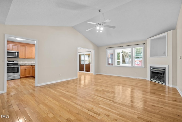 276 Sagamore Dr, Louisburg, NC 27549 - unfurnished living room with light wood-style floors, ceiling fan, a fireplace, and high vaulted ceiling