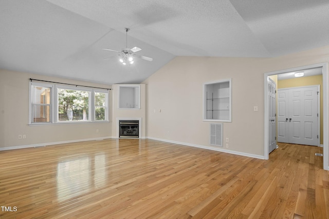 276 Sagamore Dr, Louisburg, NC 27549 - unfurnished living room with ceiling fan, lofted ceiling, light wood-type flooring, and a fireplace