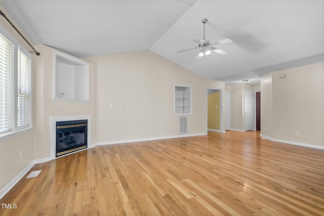 276 Sagamore Dr, Louisburg, NC 27549 - unfurnished living room featuring light wood finished floors, a glass covered fireplace, ceiling fan, and lofted ceiling