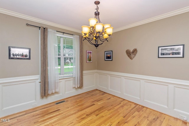 30 Cole Creek Way, Franklinton, NC 27525 - unfurnished room featuring a chandelier, light wood-style flooring, crown molding, wainscoting, and a decorative wall
