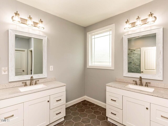 30 Cole Creek Way, Franklinton, NC 27525 - full bathroom with two vanities, tile patterned flooring, and a tile shower