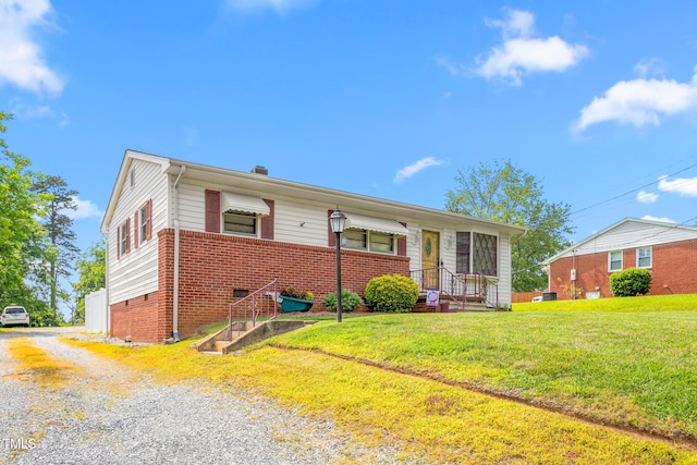 1315 Elder Way, Burlington, NC 27215 - view of front facade featuring driveway, brick siding, a front yard, crawl space, and a chimney