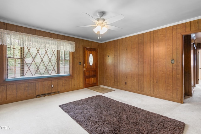 1315 Elder Way, Burlington, NC 27215 - entrance foyer featuring carpet floors, ceiling fan, ornamental molding, and wooden walls