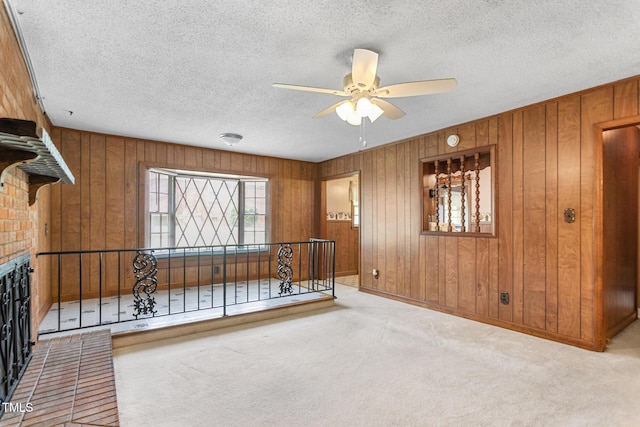 1315 Elder Way, Burlington, NC 27215 - empty room with a ceiling fan, wooden walls, carpet flooring, and a textured ceiling