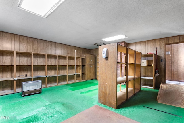 1315 Elder Way, Burlington, NC 27215 - basement featuring wooden walls, carpet flooring, and a textured ceiling