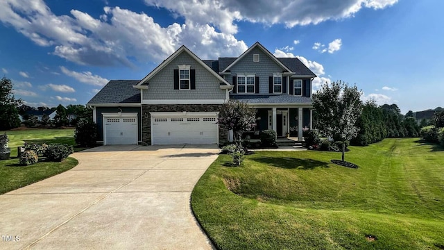 192 Waterpine Dr, Garner, NC 27529 - view of front facade with concrete driveway, a front yard, a porch, and stone siding