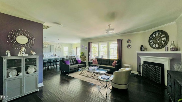 192 Waterpine Dr, Garner, NC 27529 - living room featuring crown molding, dark wood-type flooring, and a fireplace