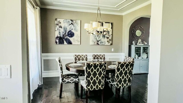 192 Waterpine Dr, Garner, NC 27529 - dining room featuring dark wood-style floors, ornamental molding, a chandelier, wainscoting, and arched walkways