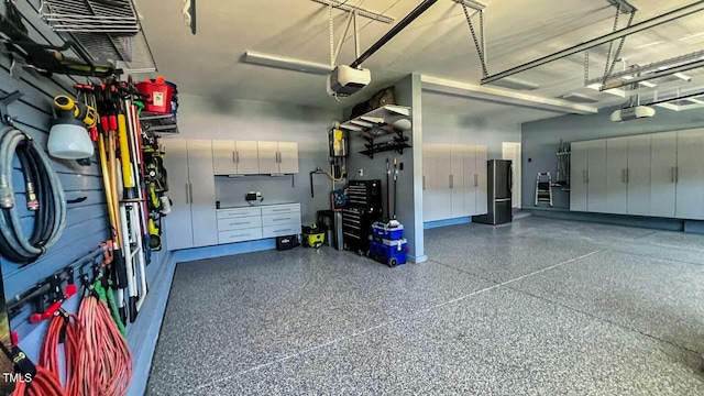 192 Waterpine Dr, Garner, NC 27529 - garage featuring a garage door opener and freestanding refrigerator