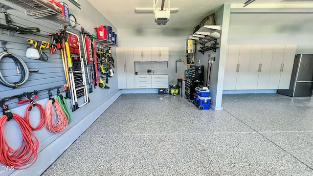 192 Waterpine Dr, Garner, NC 27529 - garage with freestanding refrigerator and a garage door opener