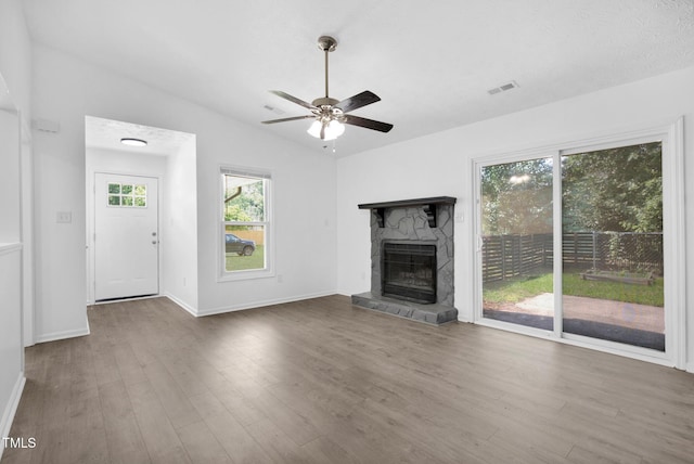 153 Eulon Loop, Raeford, NC 28376 - unfurnished living room featuring wood finished floors, a ceiling fan, a fireplace, and vaulted ceiling