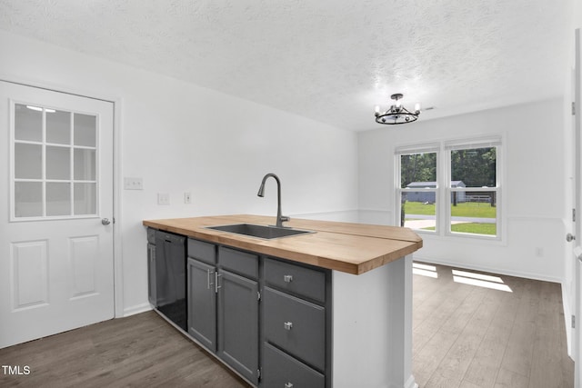 153 Eulon Loop, Raeford, NC 28376 - kitchen featuring wood counters, dishwasher, a peninsula, a textured ceiling, and dark wood-type flooring