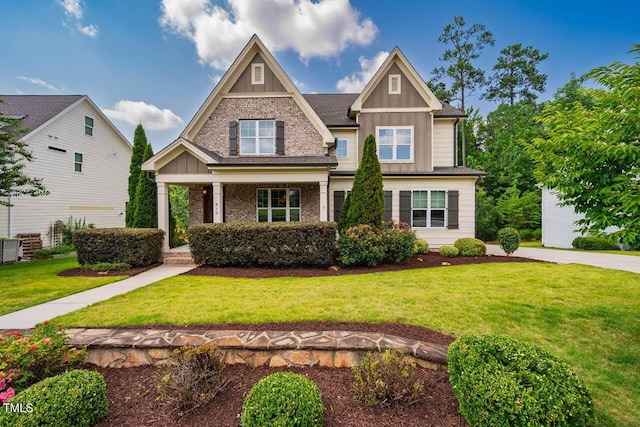 610 Bennett Mtn, Chapel Hill, NC 27516 - craftsman-style home with board and batten siding, a front lawn, covered porch, and brick siding