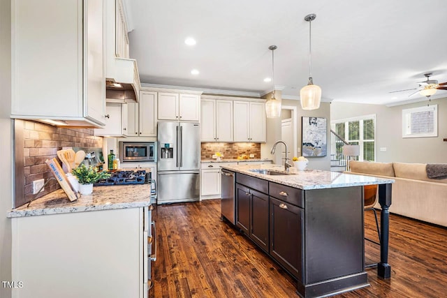 610 Bennett Mtn, Chapel Hill, NC 27516 - kitchen featuring appliances with stainless steel finishes, open floor plan, a breakfast bar, white cabinets, and backsplash