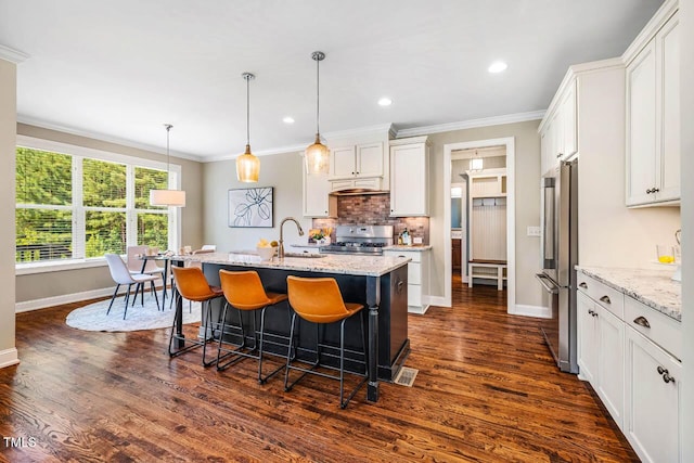 610 Bennett Mtn, Chapel Hill, NC 27516 - kitchen featuring stainless steel appliances, a breakfast bar, white cabinets, backsplash, and ornamental molding
