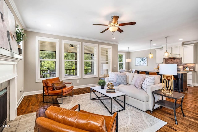 610 Bennett Mtn, Chapel Hill, NC 27516 - living area with ceiling fan, crown molding, a tile fireplace, wood finished floors, and recessed lighting