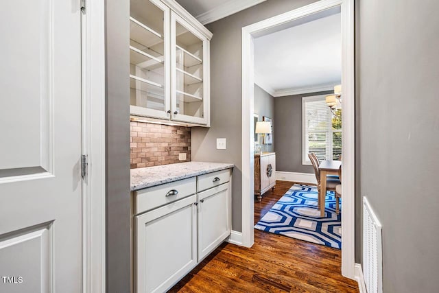 610 Bennett Mtn, Chapel Hill, NC 27516 - bar area featuring dark wood-style floors, backsplash, and crown molding