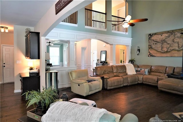 930 Old Vander Rd, Fayetteville, NC 28312 - living area featuring ornate columns, ceiling fan, arched walkways, dark wood-type flooring, and a towering ceiling