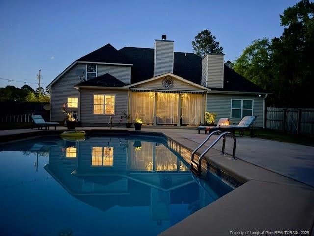 930 Old Vander Rd, Fayetteville, NC 28312 - rear view of property featuring a patio, a chimney, and a fenced backyard