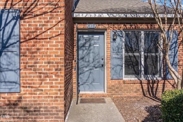 61 Fashion Pl, Durham, NC 27705 - doorway to property with brick siding and a shingled roof