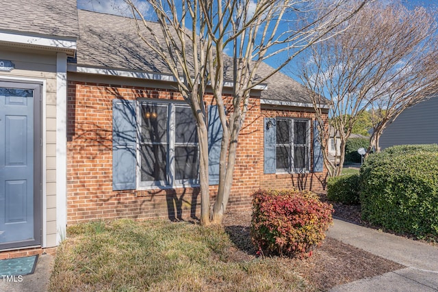 61 Fashion Pl, Durham, NC 27705 - doorway to property featuring a shingled roof and brick siding