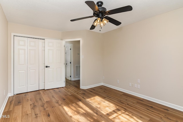 61 Fashion Pl, Durham, NC 27705 - unfurnished bedroom featuring light wood-type flooring, a closet, and ceiling fan
