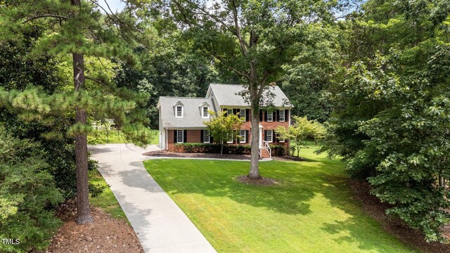 10721 Marabou Ct, Raleigh, NC 27614 - colonial home with concrete driveway, brick siding, and a front yard
